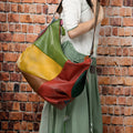 Cowhide leather travel shoulder bag in picture colour, shown with dimensions for laptop and A4 document carry.