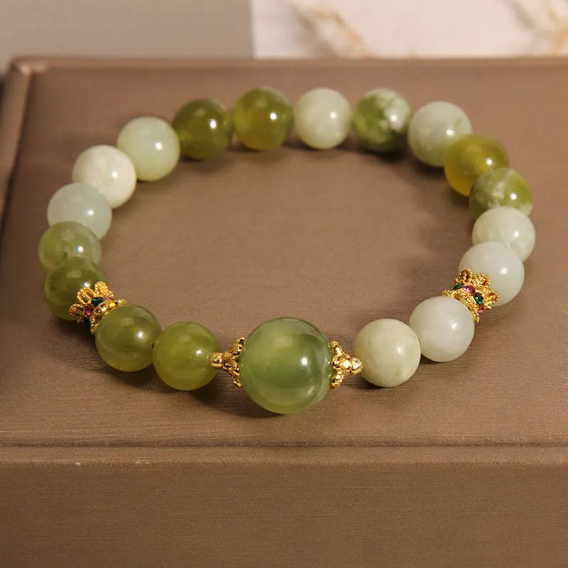 Women's bracelet made of green Xiuyan jade with an original design on a wrist.