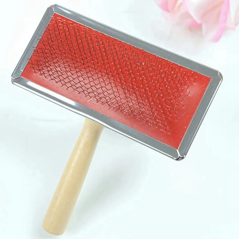 Red pet needle comb dog grooming comb with wooden handle and stainless steel plate on a neutral background