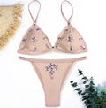 Women's pink crystal bling diamond bikini set with push-up top and Brazilian low-waist bottom on model
