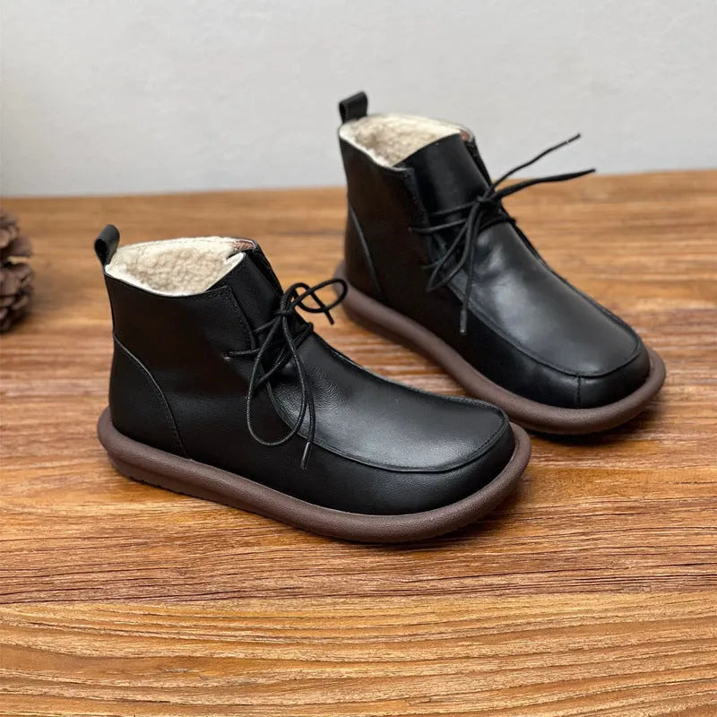 Women's black cowhide ankle boots with velvet lining, flat heel, and round toe