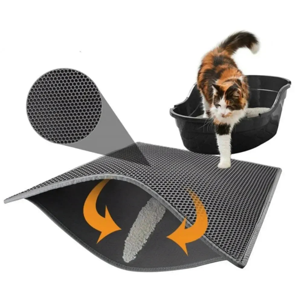 Black waterproof EVA cat litter mat with honeycomb texture and quilted edge on a wooden floor