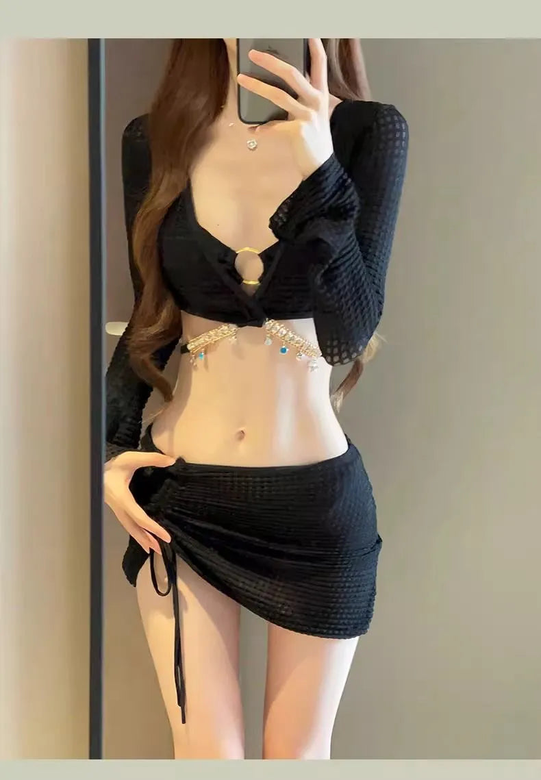 Women's black long sleeve bikini swimsuit with split hot spring design on white background
