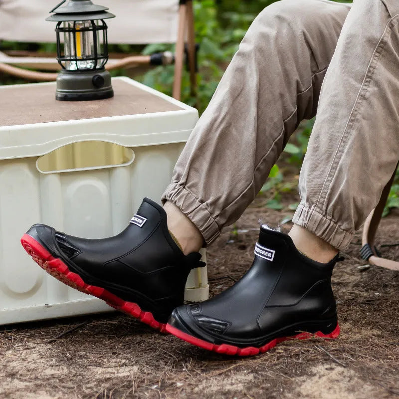 Pair of large size fixed velvet PVC rain boots in black, with round toe and flat heel, for outdoor use