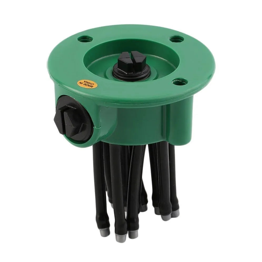 Green adjustable lawn sprinkler with bendable spray arms on a 9cm circular base.