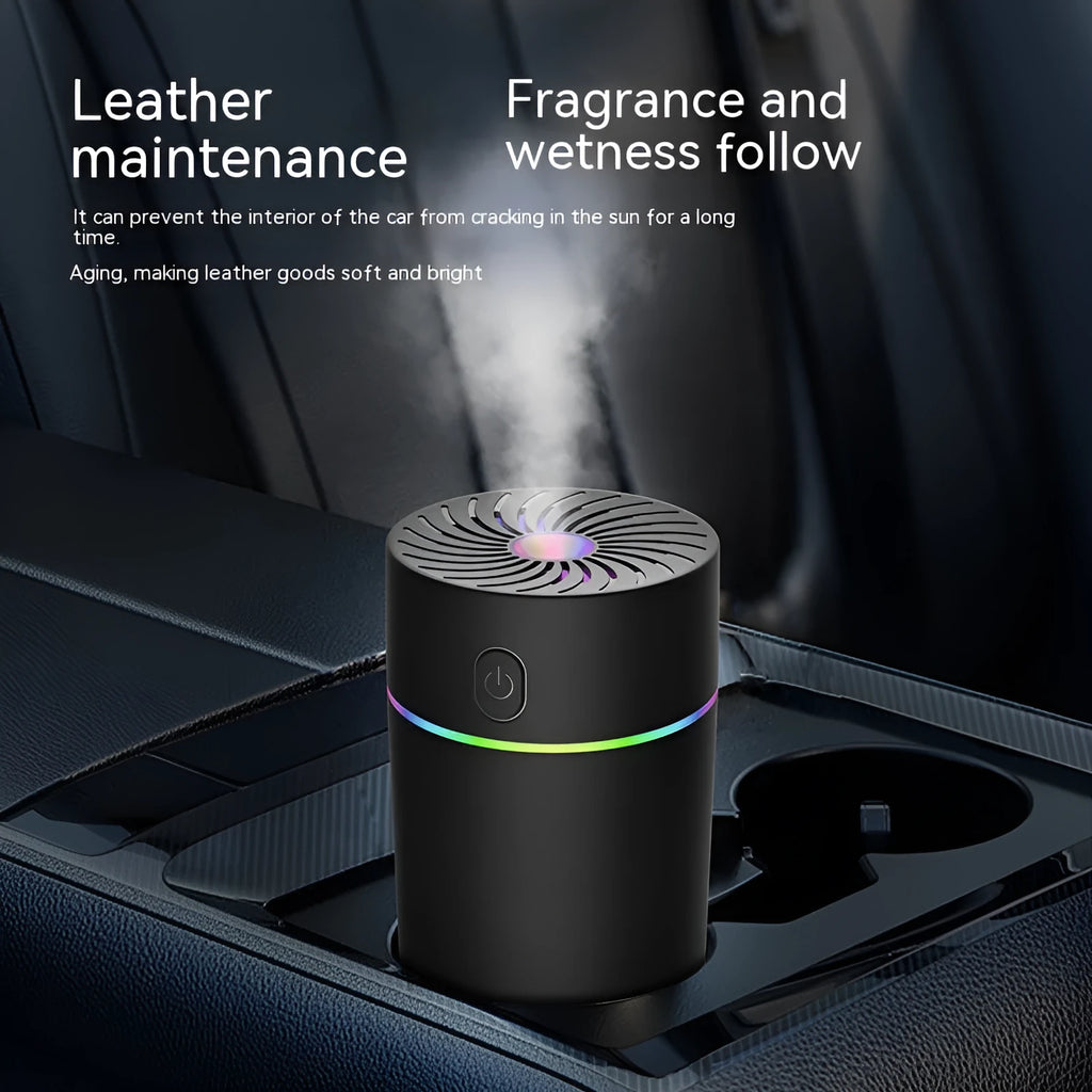 Compact black car USB mini humidifier with aromatherapy function on a car dashboard.