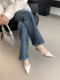 Black pointed toe low heel women's shoes with an ankle strap and rubber sole.
