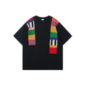 Men's loose fit grey T-shirt with a black and white patchwork letter design on the chest.