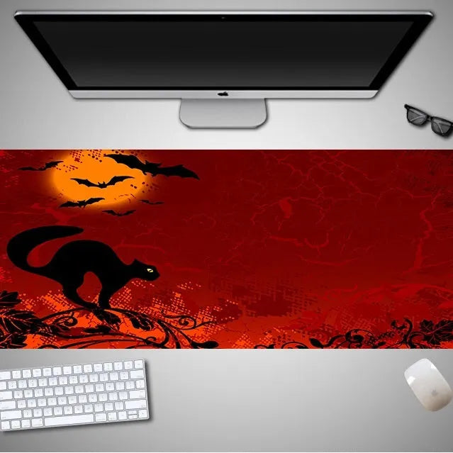 Oversized Halloween gaming mouse pad with non-slip rubber base on a desk
