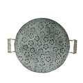 Round wrought iron belt storage tray with raised rim in two sizes on a wooden table.