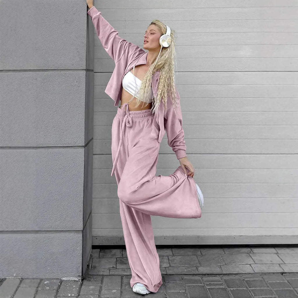 Women's velvet-look two-piece suit with drop-shoulder top and full-length trousers, available in grey or pink, sizes S to L