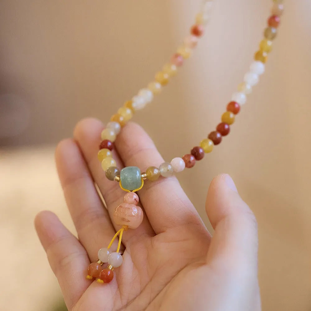 Women's Jinsi Jade bracelet with three pumpkin beads and tassel decoration on wrist