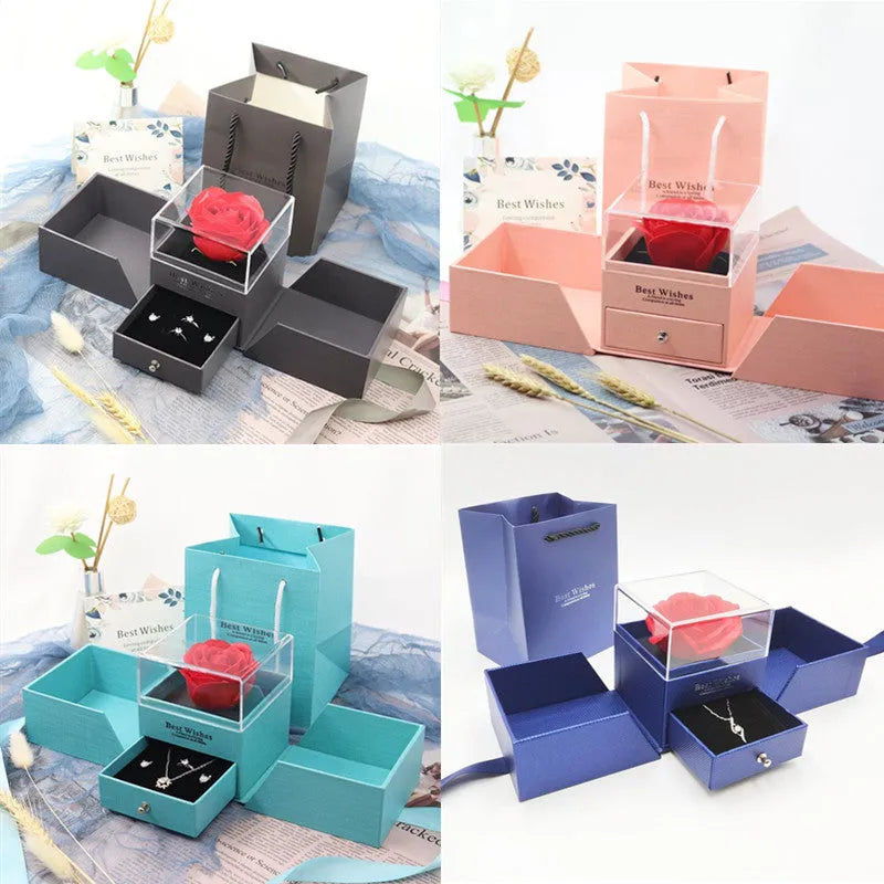 Blue gift box with a built-in plastic red rose, holding earrings and a necklace inside.