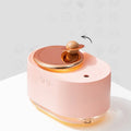 Green rotating planet humidifier with USB cable and 0.5L water tank on wooden desktop