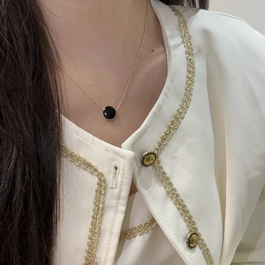 Women's compass necklace with round black agate inlay, geometric pendant, and curb chain in gold or platinum colour