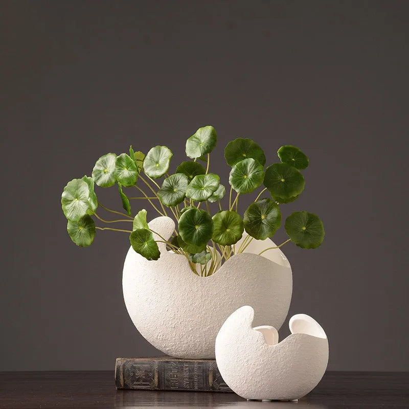 White ceramic countertop vase in simple modern style, shown in large medium and small sizes for living room desktop or study