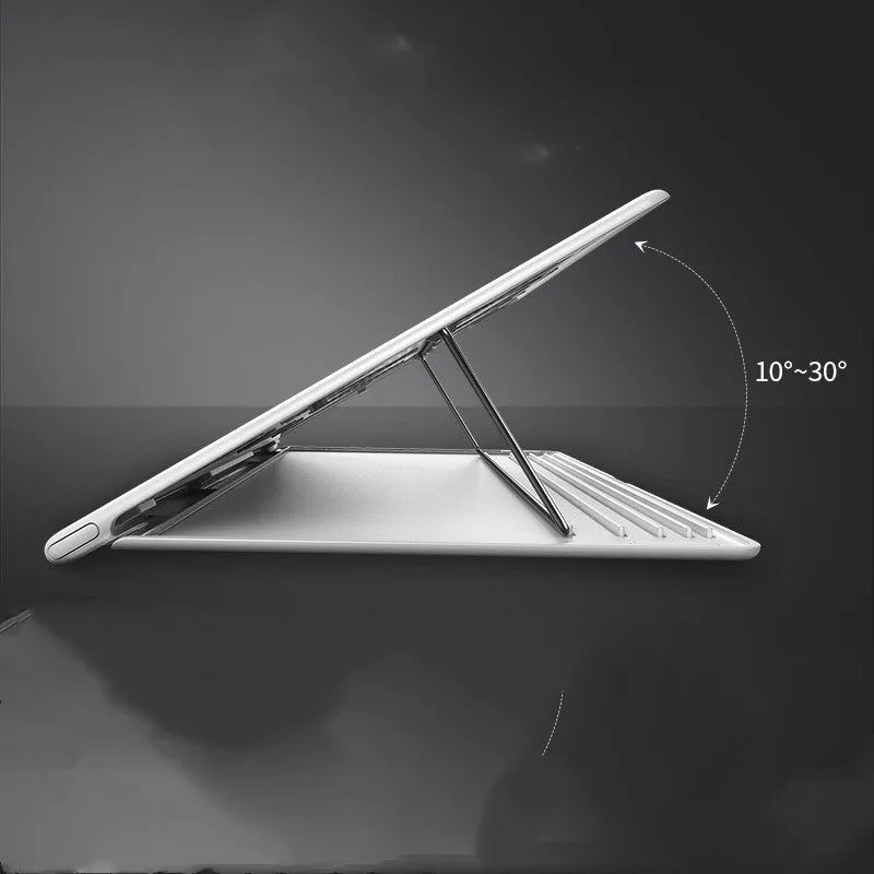 Portable black metal alloy laptop stand folded to 0.8mm thickness next to a notebook computer.