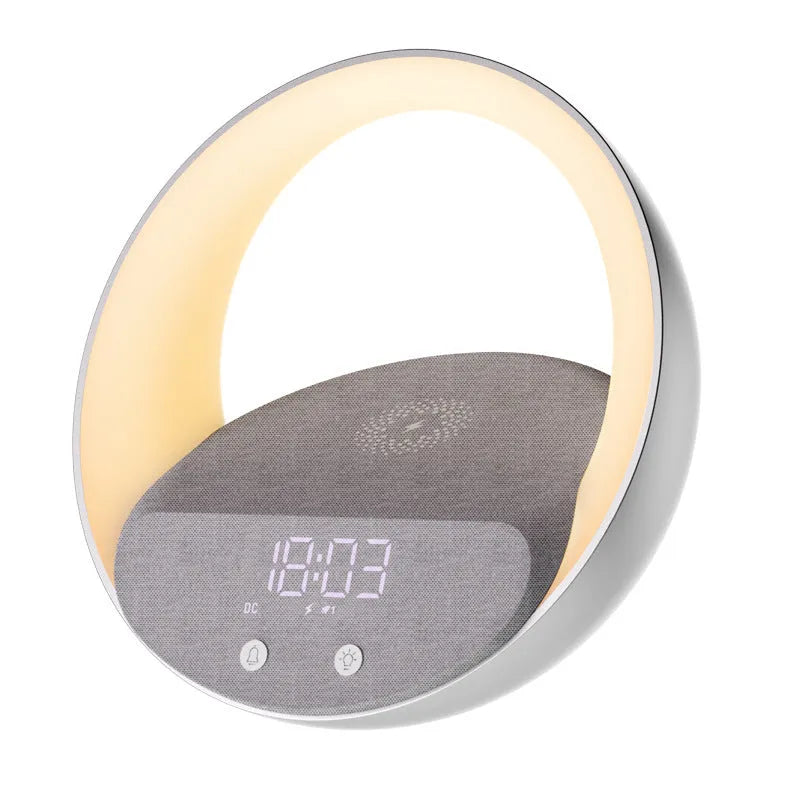 Beige multifunctional wireless charger clock with Bluetooth speaker and LED wake-up light on a bedside table.