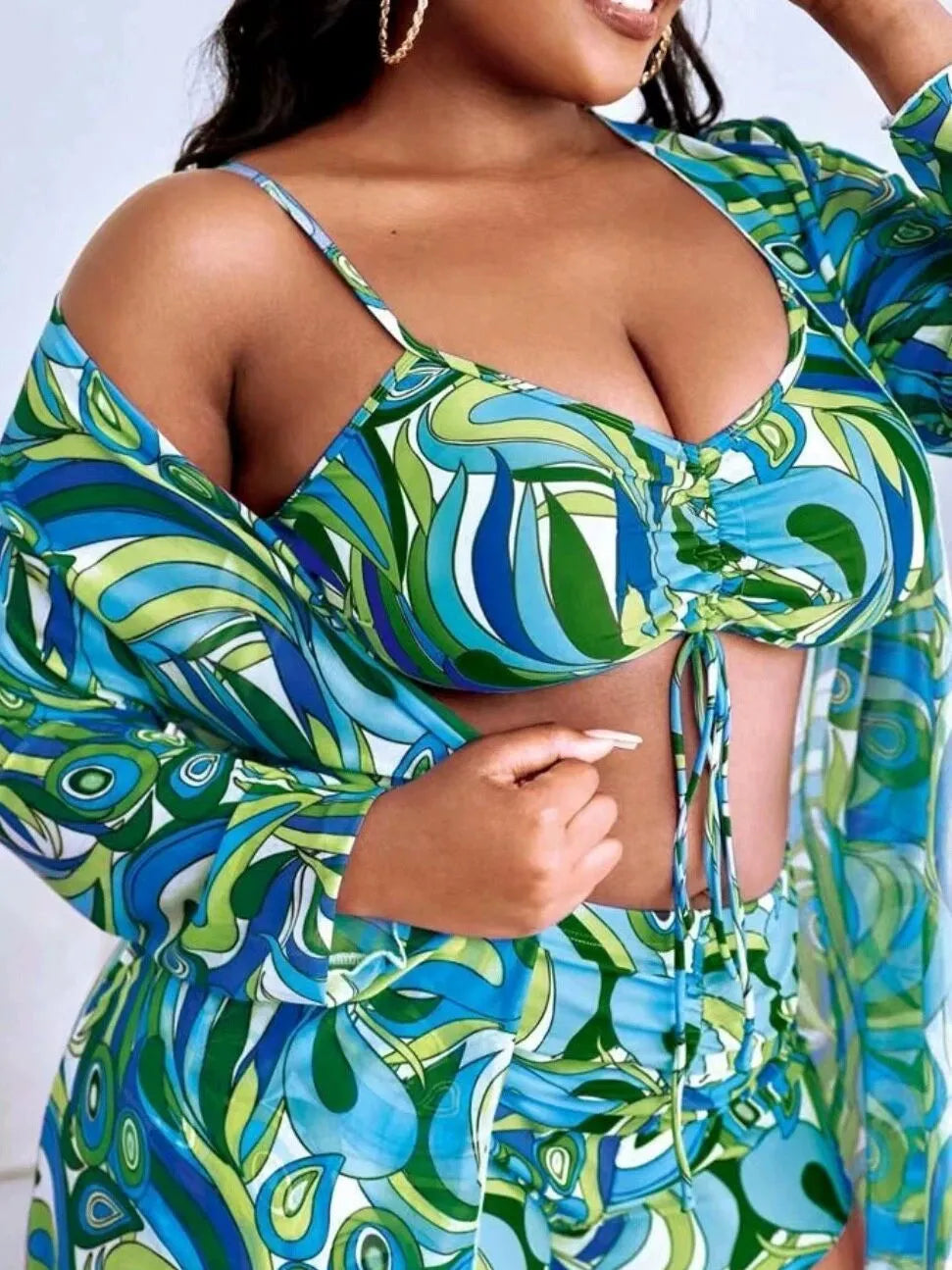 Women's floral print bikini three-piece set with bra, briefs, and a matching cardigan cover-up.