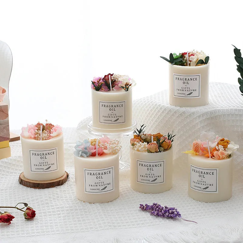 Aromatherapy candle with dried flowers embedded in the wax, shown next to its optional gift box packaging.