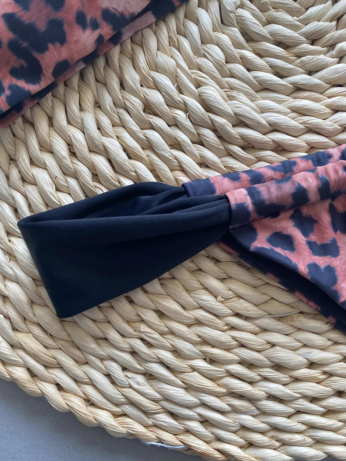 Women's leopard print tube top bikini set with matching T-pants on a mannequin.