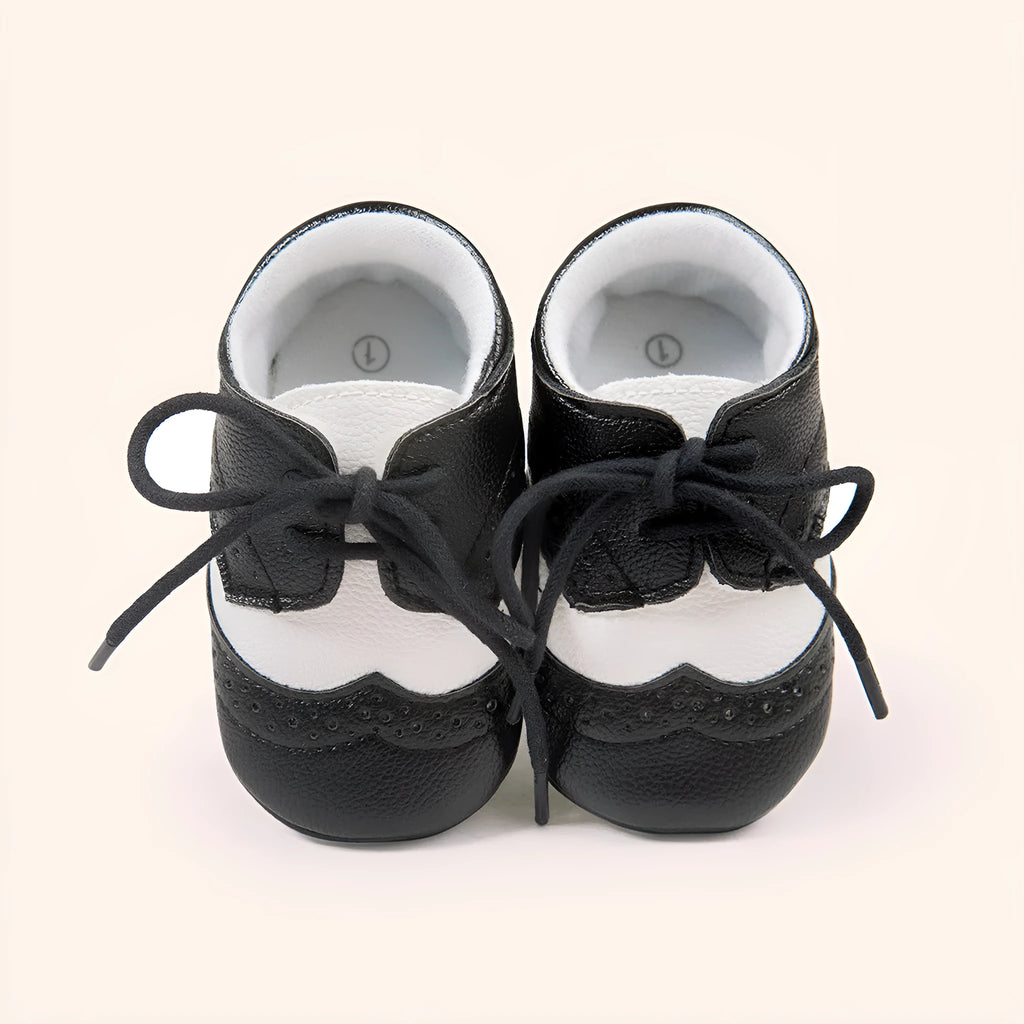 Vintage-style soft-soled baby shoes in synthetic leather, shown in light brown.