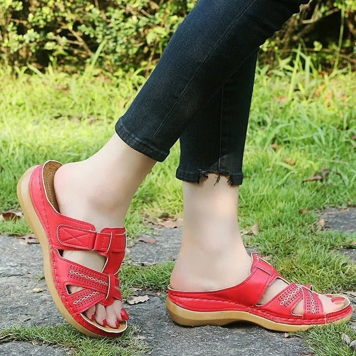 Women's red peep toe wedge sandals with a Velcro strap and hollow wedge heel.