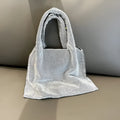 Silver handbag with shiny rhinestone decoration and open pocket design