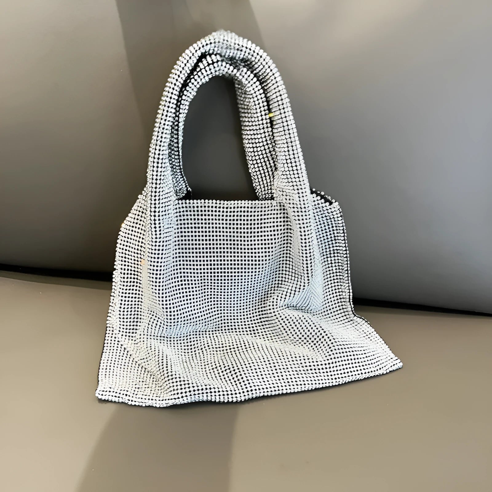 Silver handbag with shiny rhinestone decoration and open pocket design