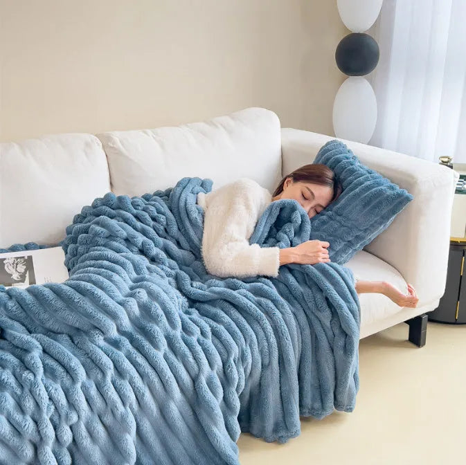 Soft bubble velvet faux rabbit fur blanket in a solid colour, shown draped over a sofa.