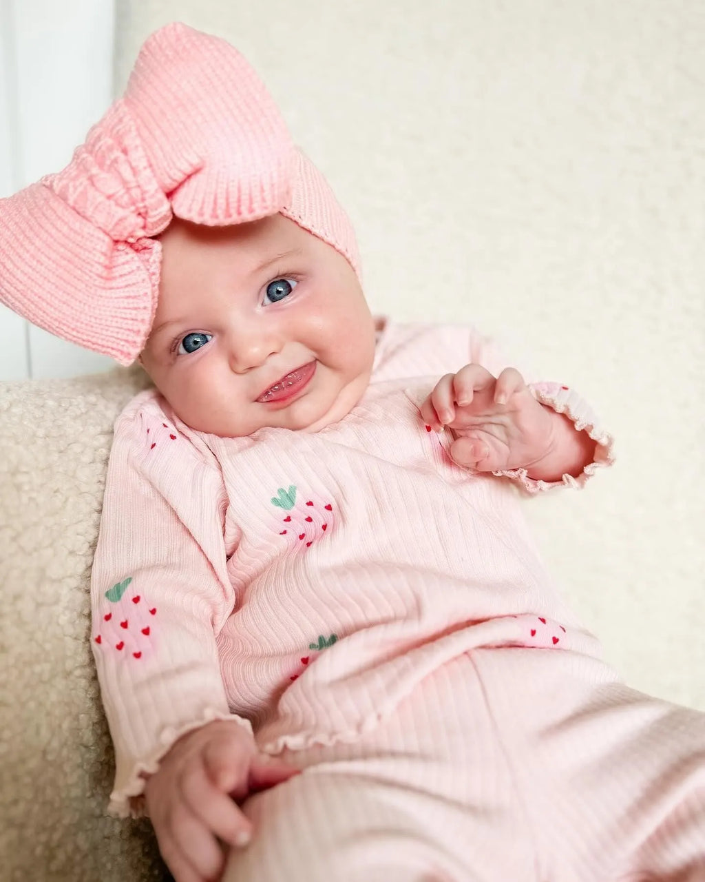 Infant wearing a printed long-sleeve top, solid trousers, and matching cap from the 3-piece suit set.