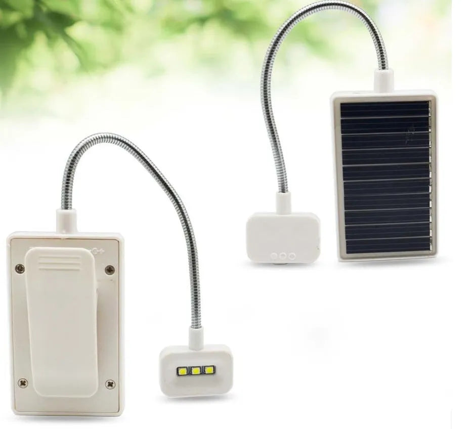 White solar garden lamp with plastic shade and integrated solar panel for outdoor decorative lighting.