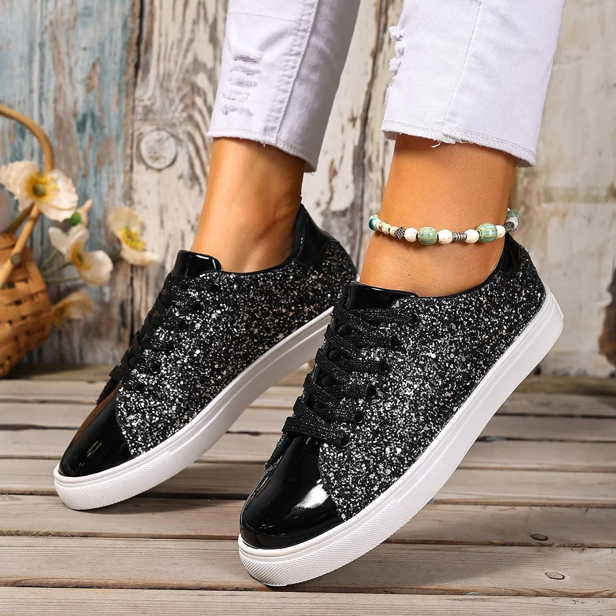 Women's plus size black sequin lace-up flat board shoes on a plain background