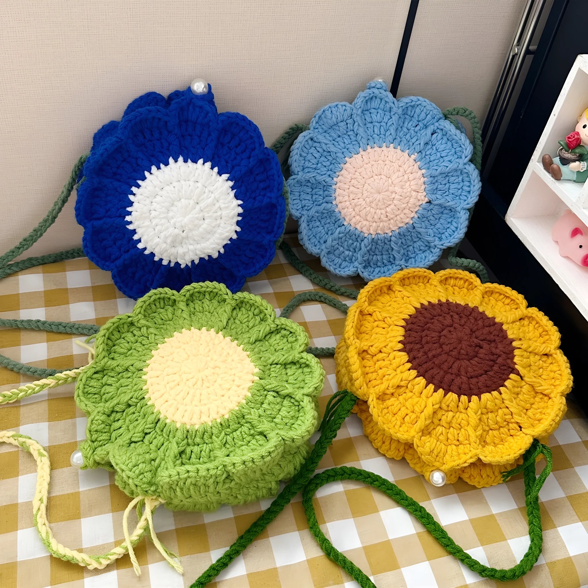 Hand-woven wool bag with crocheted flowers and round suitcase shape