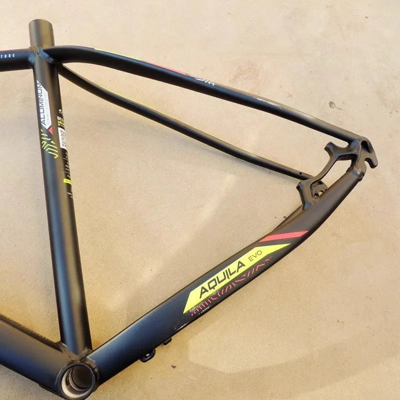 29-inch aluminium mountain bike frame in black green colour with disc brake mounts and internal cable routing