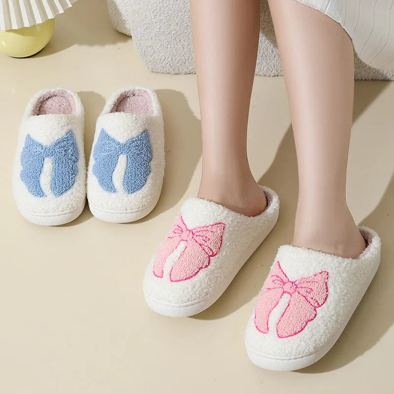 Cotton slippers with cartoon bow knot design on suede upper in pink or blue colours with TPR sole