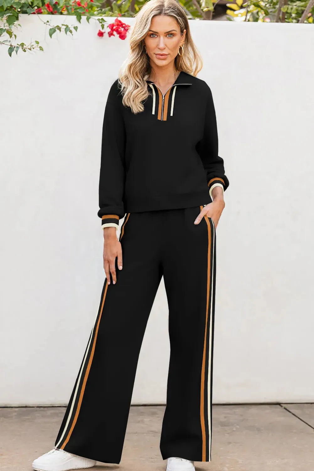 Black striped patchwork quarter zip pullover and loose pant set for women, two-piece outfit in polyester viscose elastane blend.