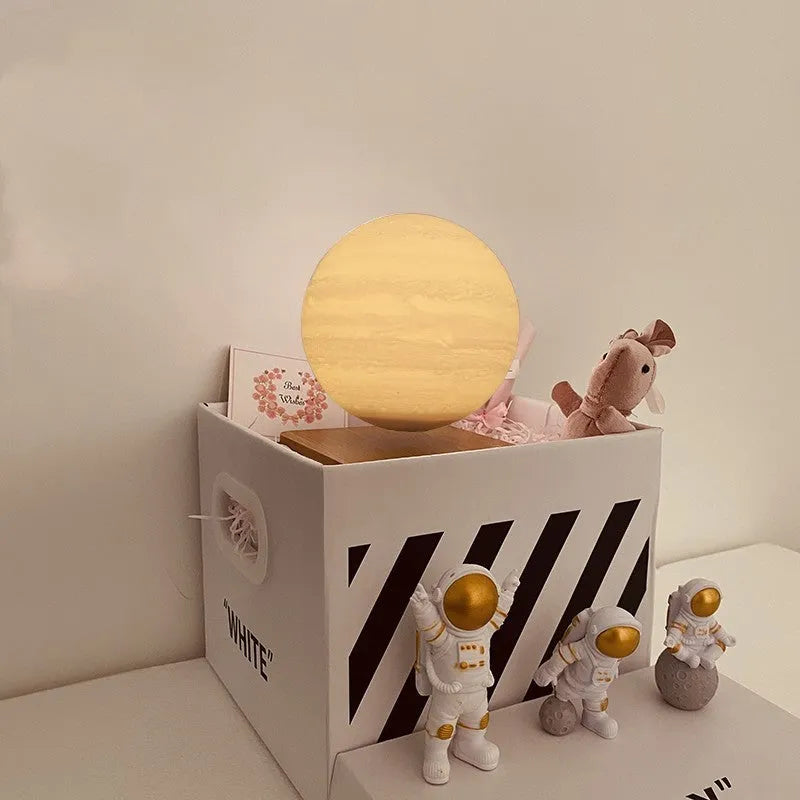 Maglev floating moon planet atmosphere night light with LED illumination on a desk.
