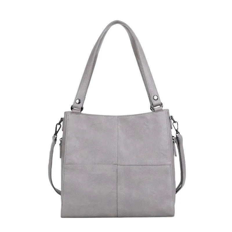 Soft PU retro style crossbody handbag in barrel shape showing pocket sandwich design.