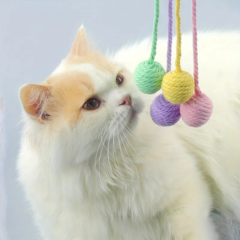 Colourful cat toy ball with attached rope and internal bell for kitten play