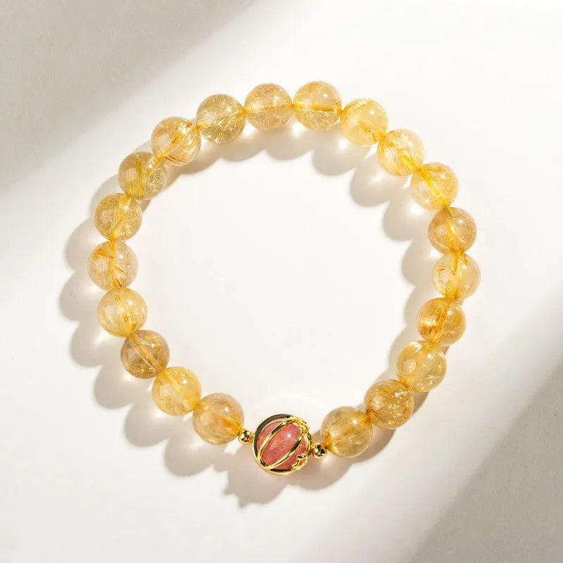 Gold rutilated quartz crystal bracelet with diamond-cut beads in a Korean-style design.