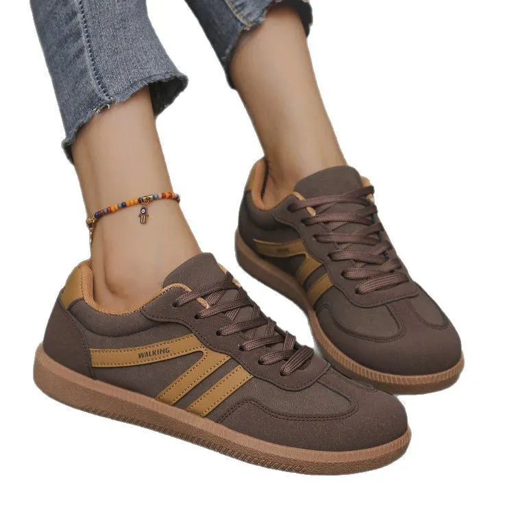 Plus size low-top sneaker in artificial PU with flat rubber sole and lace-up front, shown in multiple colour options.