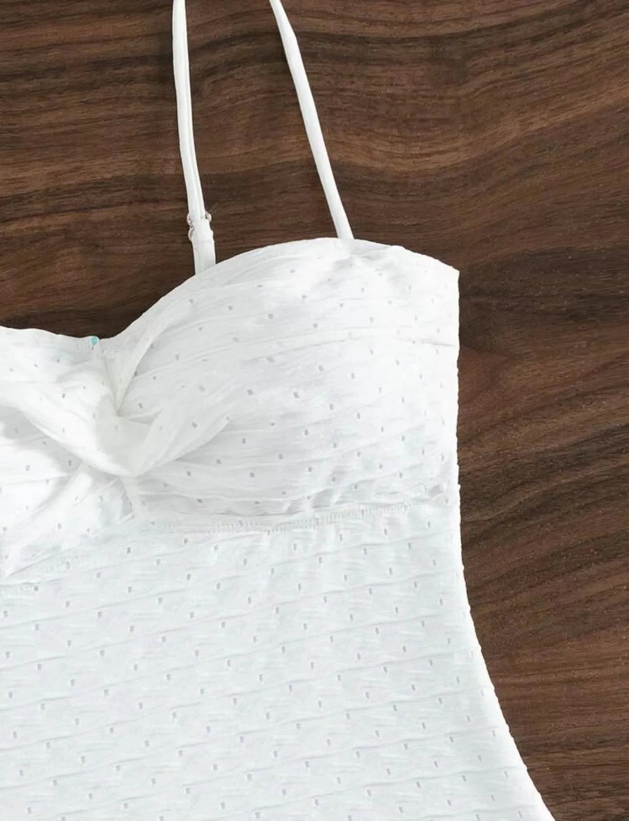 White women's one-piece swimsuit with sling style and brief cut design on mannequin