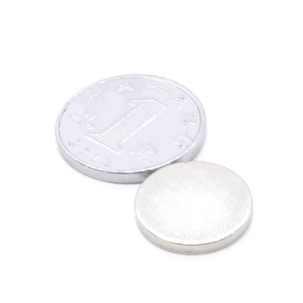 Rare earth NdFeB magnet disc 14x2mm silver N35 grade on white background