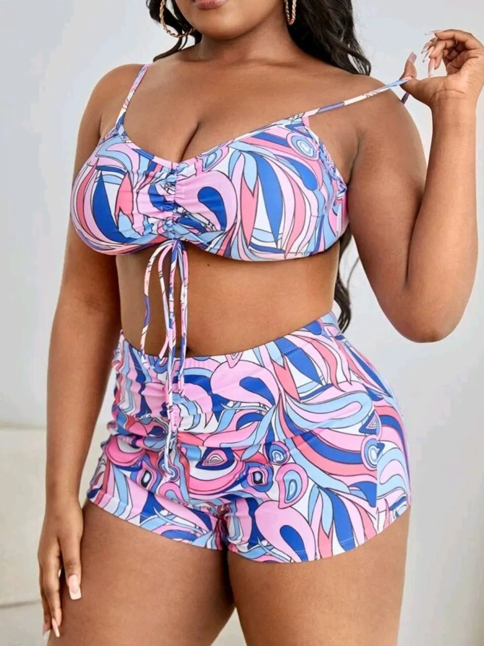 Women's floral print bikini three-piece set with bra, briefs, and a matching cardigan cover-up.