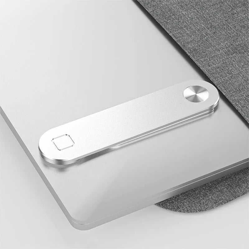 Black magnetic laptop phone holder clip attached to a monitor with a smartphone mounted.