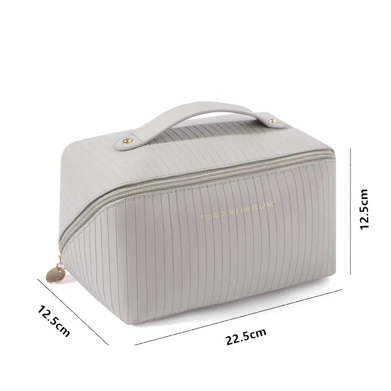 Vertical pattern pillow makeup bag in PU material measuring 22.5cm cubic for travel storage