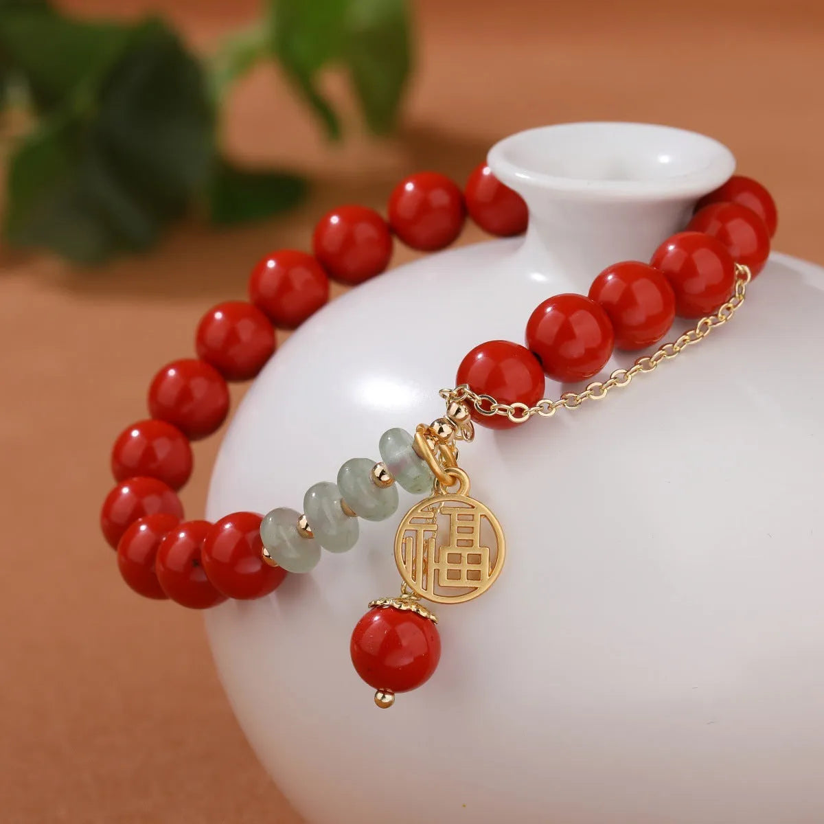 Retro red cinnabar bracelet with carved fu character, jade bead, and leather tassel cord