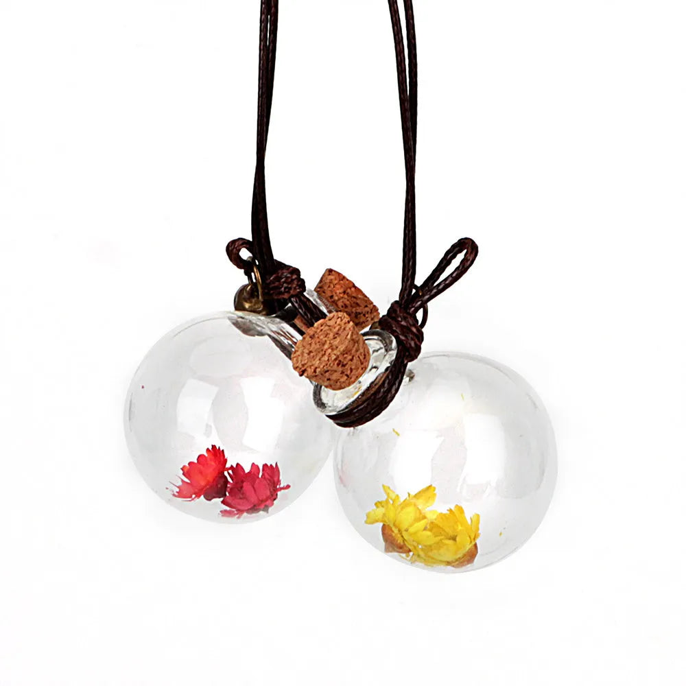 Car pendant perfume bottle with 2.8cm high borosilicate glass ball and Brazilian small star flower in Blue, Green, Pink, or White.
