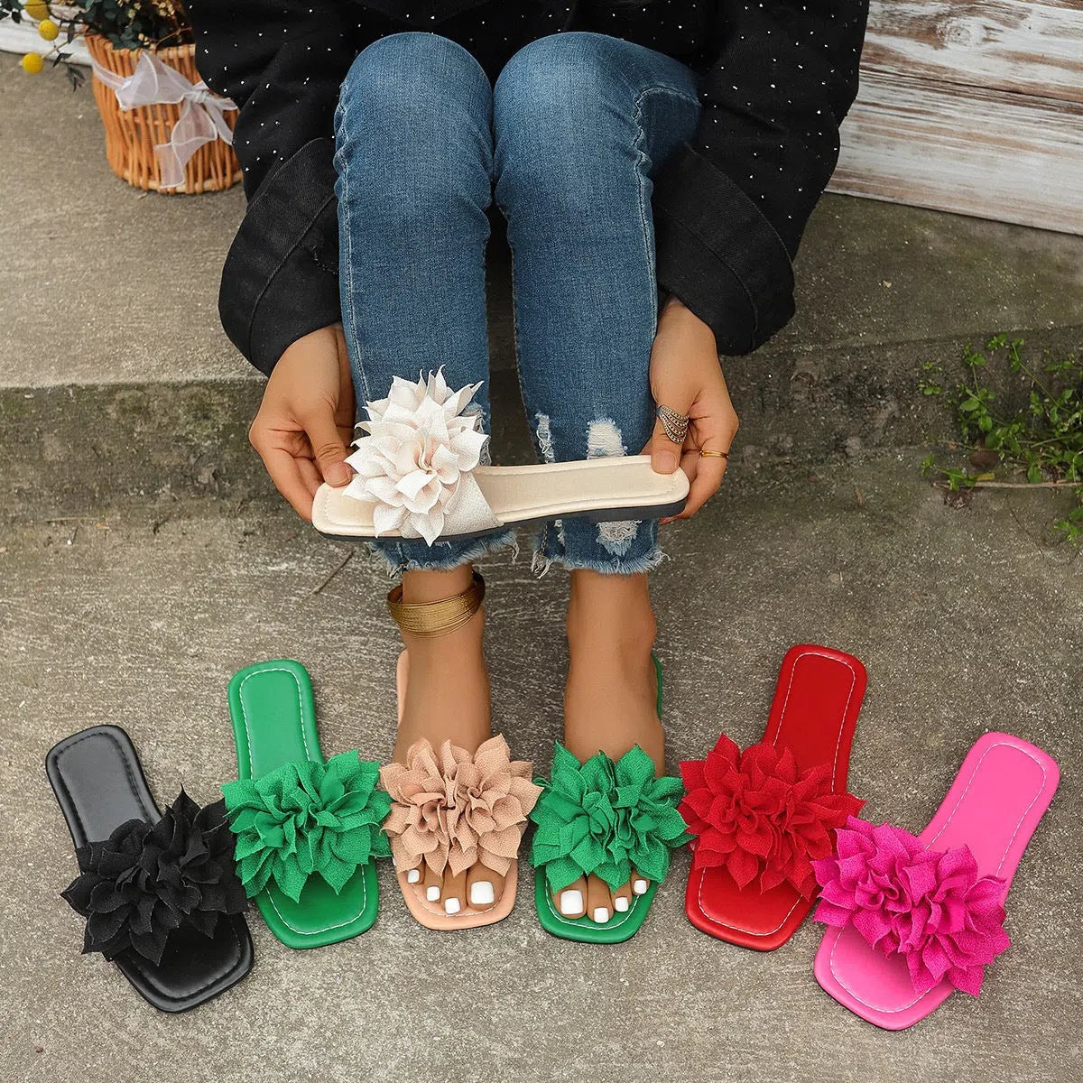 Women's flat flip-flops with flower detail on PU upper, available in apricot, black, white, red, and green